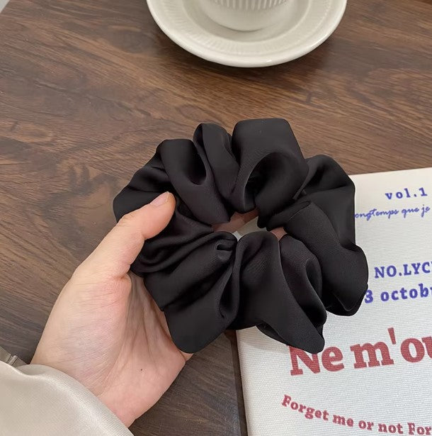 "Big satin silk scrunchies in vibrant colors, perfect for all hair types."
