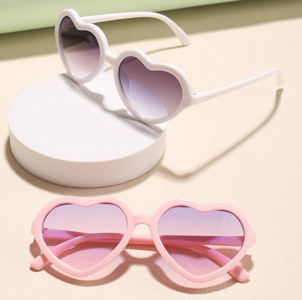"Close-up of stylish heart-shaped glasses one size fits 4-7 years."