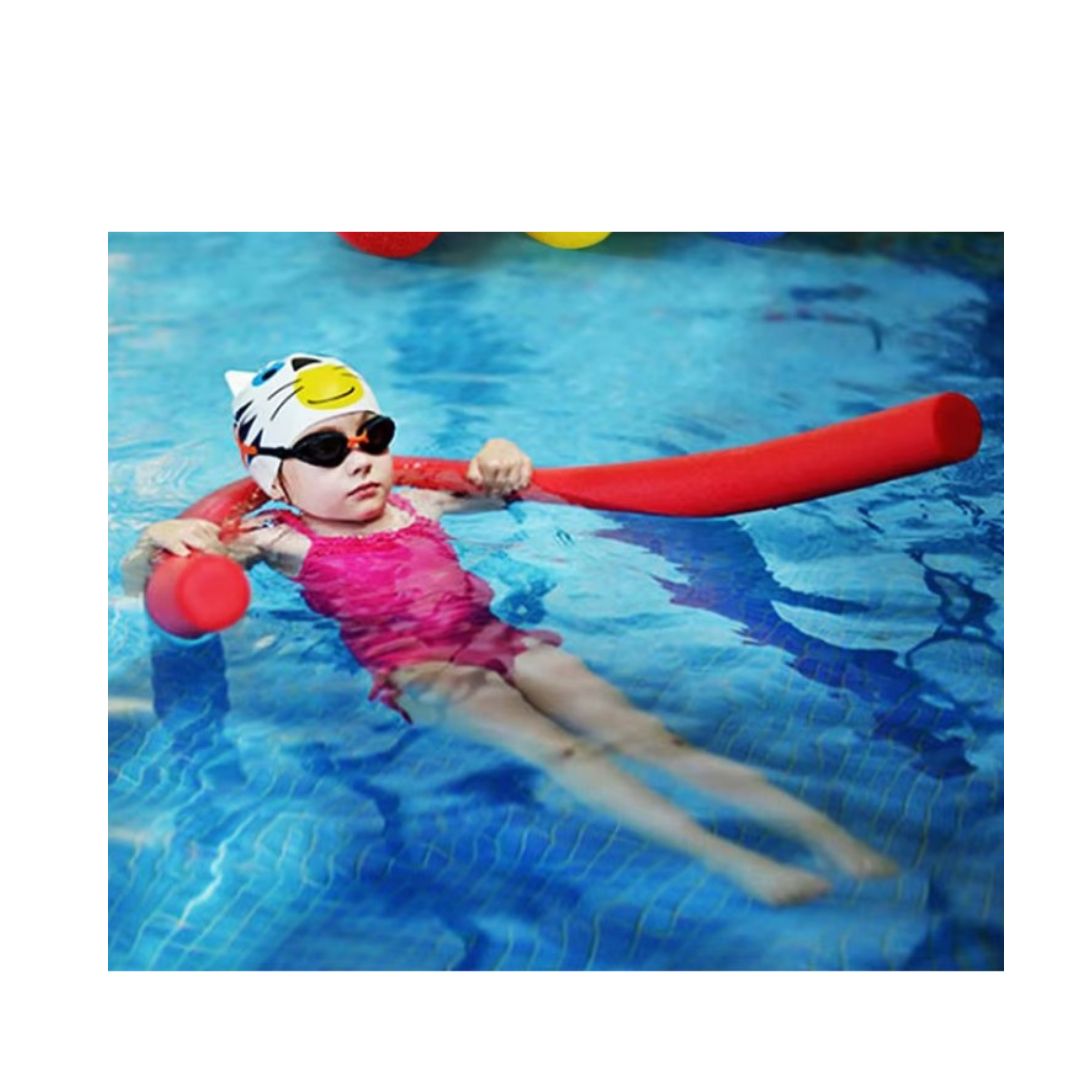 "Child in a pool wearing a swim cap and goggles, holding a red pool noodle"