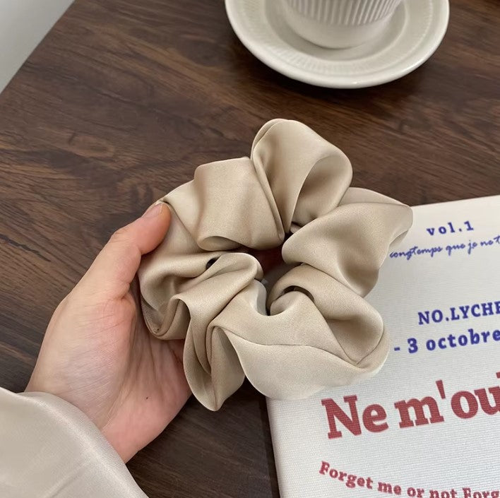 "Chic satin silk scrunchies for stylish hairdos without breakage."