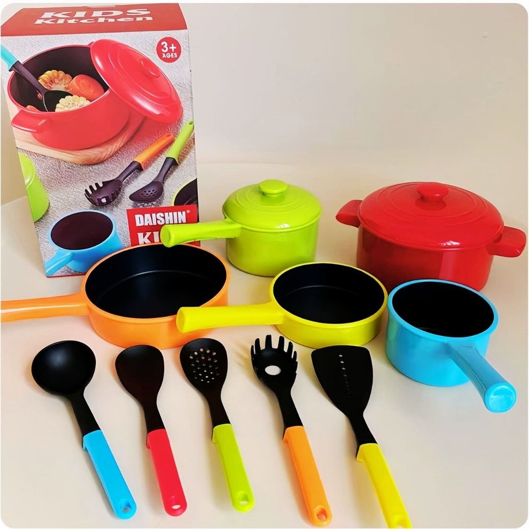 
"Colorful toy kitchen set with pots, pans, and utensils next to a box labeled 'Kids Kitchen' by Daishin."